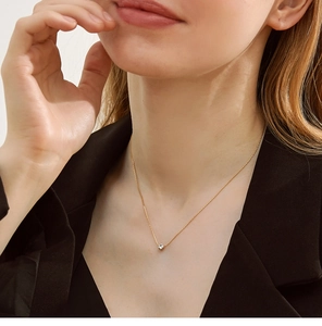 Close-up of 18K gold-plated titanium necklace with round zircon pendant on model
