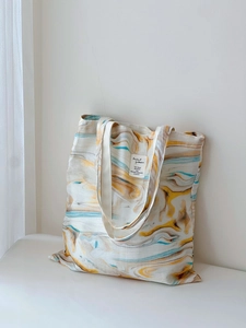 Detail of artistic marble pattern canvas tote bag with long shoulder strap