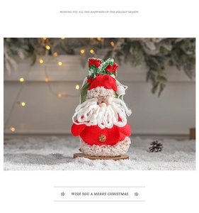 Detail of Santa Claus felt gift bag with curly beard and festive knitted trim on snow