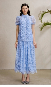 Detail of light blue lace two-piece set featuring intricate floral texture and ruffles