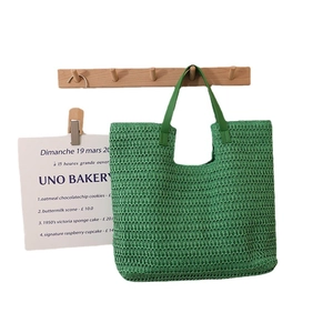 Green woven straw tote bag with large capacity for beach vacations and summer travel