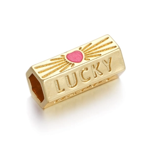Detail of gold-plated hexagonal pendant with pink heart and LUCKY engraving