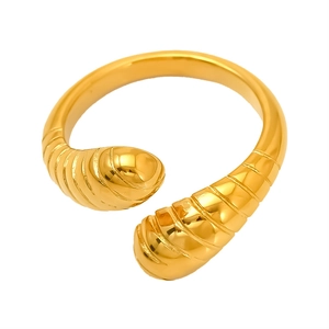 Modern golden stainless steel open ring featuring a unique spiral texture on white background