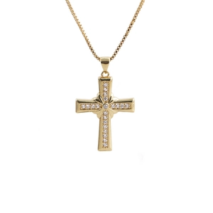 Macro shot of gold cross pendant with cubic zirconia on a square box chain