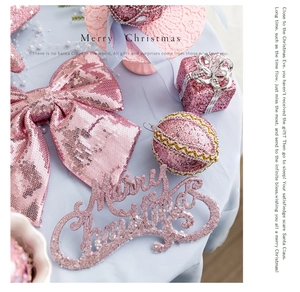 Pink glitter Christmas bow and Merry Christmas sign set on light blue velvet fabric