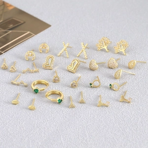 Golden micro-pave zircon earring set featuring tree of life, moon, and heart designs