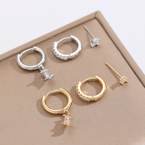 Macro shot of gold and silver sun and moon earrings with cubic zirconia inlays