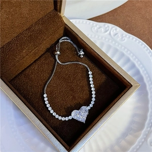 Macro detail of silver heart bracelet with sparkling zircons in a velvet gift box