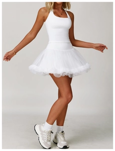 Detail of white yoga set featuring layered mesh ballet skirt and slim fit tank top