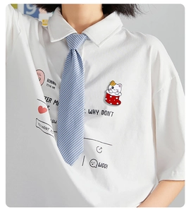 Detailed view of cute Christmas cat in stocking enamel pin worn on a white shirt collar