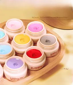 Macro view of 21 colors of solid cream nail polish jars on a wooden tray