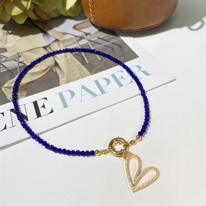 Deep blue beaded necklace with a golden heart pendant and sparkling crystals