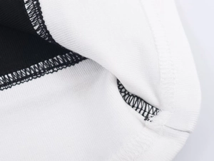 Close-up of contrast color stitching and knitted rib texture on the T-shirt sleeve