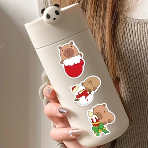 Close-up of insulated tumbler with cute Capybara Christmas stickers and panda lid decoration