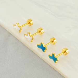 Detailed macro view of gold-plated cross earrings with white and blue enamel inlay