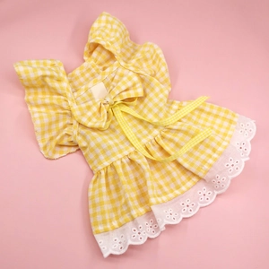 Detail of yellow plaid pet dress with delicate white lace trim and bow knot decoration