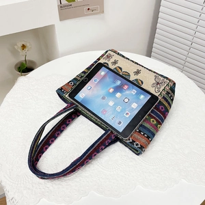 Detail of bunny embroidery on ethnic canvas tote showing its tablet storage capacity