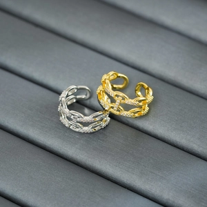 Macro shot of double-layer chain rings in gold and silver finish with zircon micro-paving