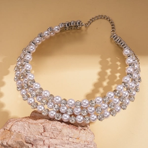 Detail view of triple-strand pearl choker with crystal accents and adjustable silver chain