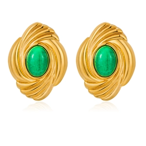 Close-up of vintage gold earrings with oval green stone and spiral texture