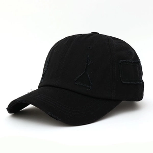 Distressed black cotton baseball cap with ripped details in a 45-degree angle view