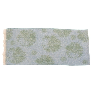 Detail shot of light blue scarf featuring green floral patterns and fringed edges