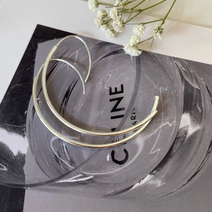 Detailed macro view of S925 hallmark on minimalist silver wave hoop earrings