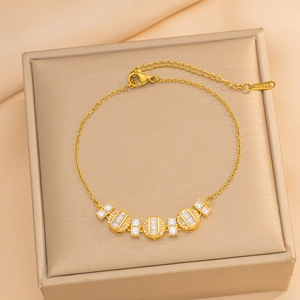 Elegant gold stainless steel bracelet with geometric zircon stones on a velvet box