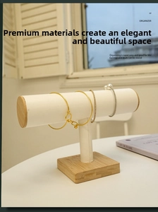 Minimalist T-bar jewelry display stand with white leather bar and light wood base stand
