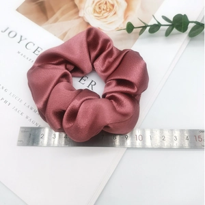 Burgundy satin oversized scrunchie with soft pleated texture and elegant silk finish