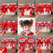 Detail of red Chinese style hair clips with embroidery bows, tassels, and bells for girls