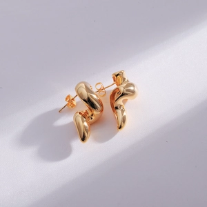Modern double-layered gold teardrop stud earrings with a minimalist wavy design