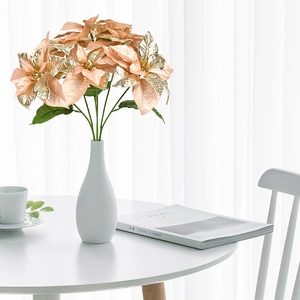 Artificial champagne pink poinsettia bouquet in a white vase for home Christmas decor