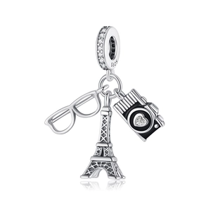 Macro view of 925 silver charms including Eiffel Tower, vintage camera, and glasses