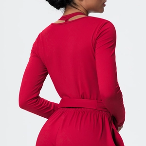 Detail of cross-back hollow design and sleek red fabric on long sleeve yoga top