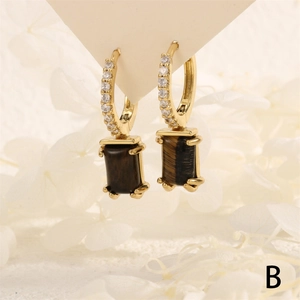 Detailed shot of 18K gold-plated hoop earrings with micro-set zircon and tiger eye pendant