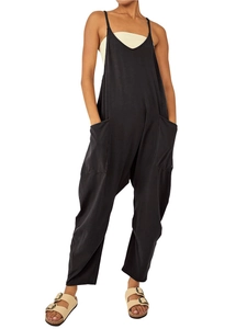 Detail of black baggy jumpsuit with large utility pockets and adjustable thin straps