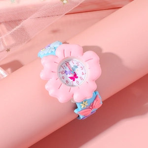 Close-up of pink flower-shaped dial watch with blue butterfly strap on pink display stand