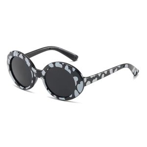 Detail of round black pet sunglasses with grey abstract pattern on a white background
