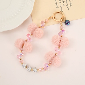 Pink plush ball and crystal bead keychain wristlet with golden metal clasp and bell