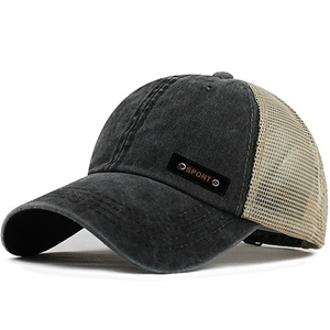 Detail of a mesh trucker hat featuring washed cotton fabric and side Sport label