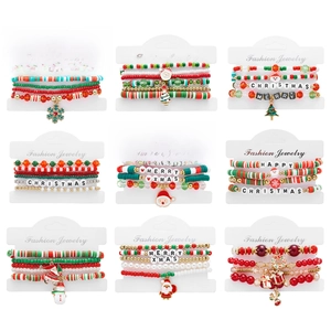 Close-up of 9-piece Christmas beaded bracelet set featuring Santa and tree charms