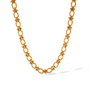 Detail of 18K gold plated stainless steel chain with twisted texture and spherical links