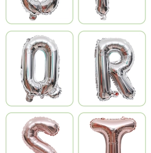 Detail of silver and rose gold foil alphabet balloons Q R S T with metallic luster