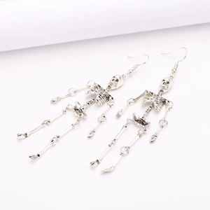 Detail view of silver punk skeleton earrings with metallic joints on white background