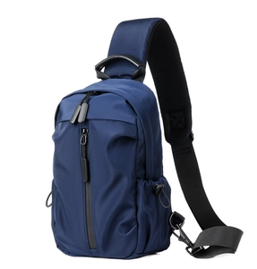 Detail of dark blue waterproof chest bag featuring multiple zipper pockets and adjustable strap