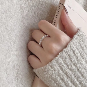 Minimalist geometric S925 sterling silver ring worn on hand with cozy knit background