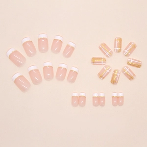 Detailed view of 24pcs nude pink press-on nails with French white tips and gold glitter grid