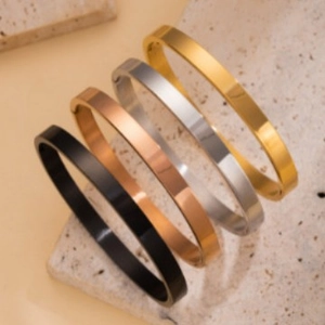Minimalist egg-shaped stainless steel bangles in gold, rose gold, silver, and black finish