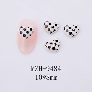 Detail of 10x8mm heart-shaped checkerboard nail art charms with black and white enamel